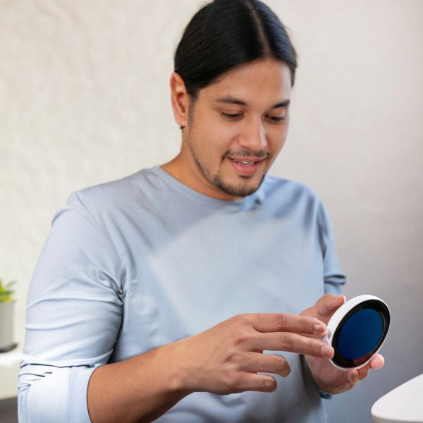 Young man using a smart speaker for voice search