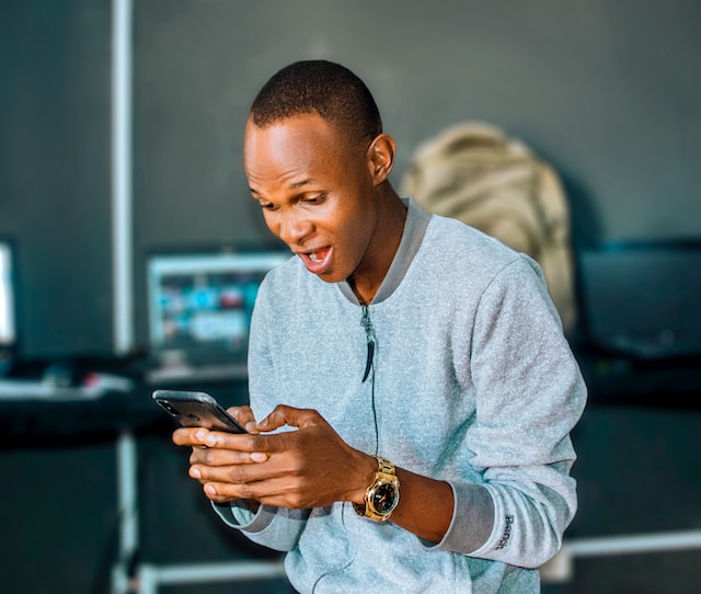 Surprised man using a smartphone