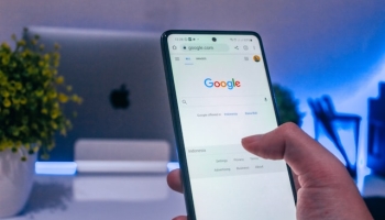 Person clicking on PPC ad on laptop