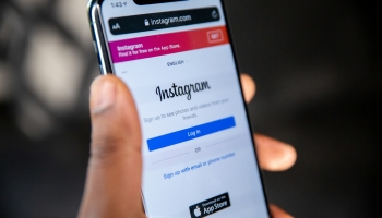 Holding Instagram smartphone app in hand
