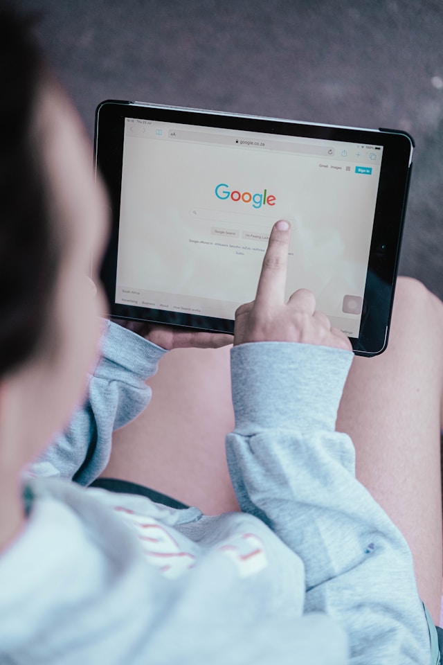 Person searching Google on a tablet